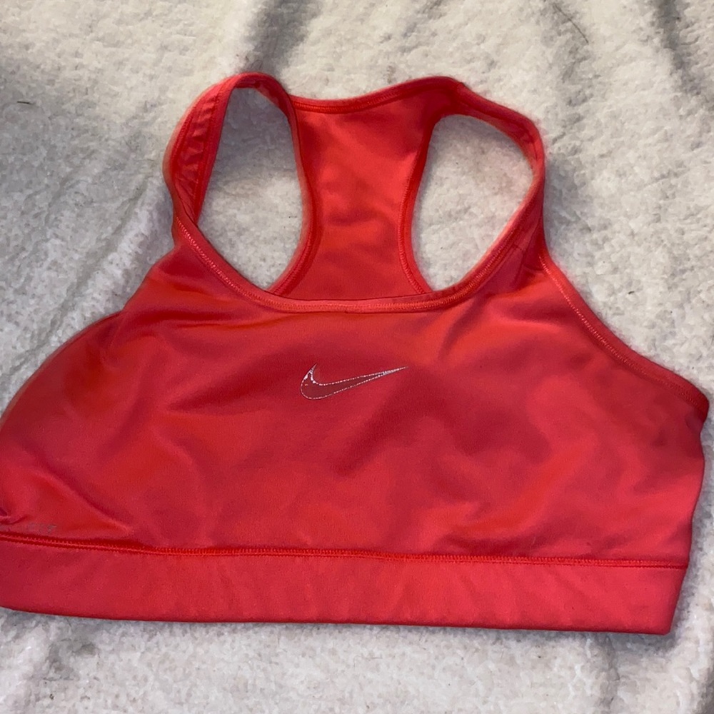 Nike dri fit racerback sports bra , has faded logo and a few dots of tiny stains